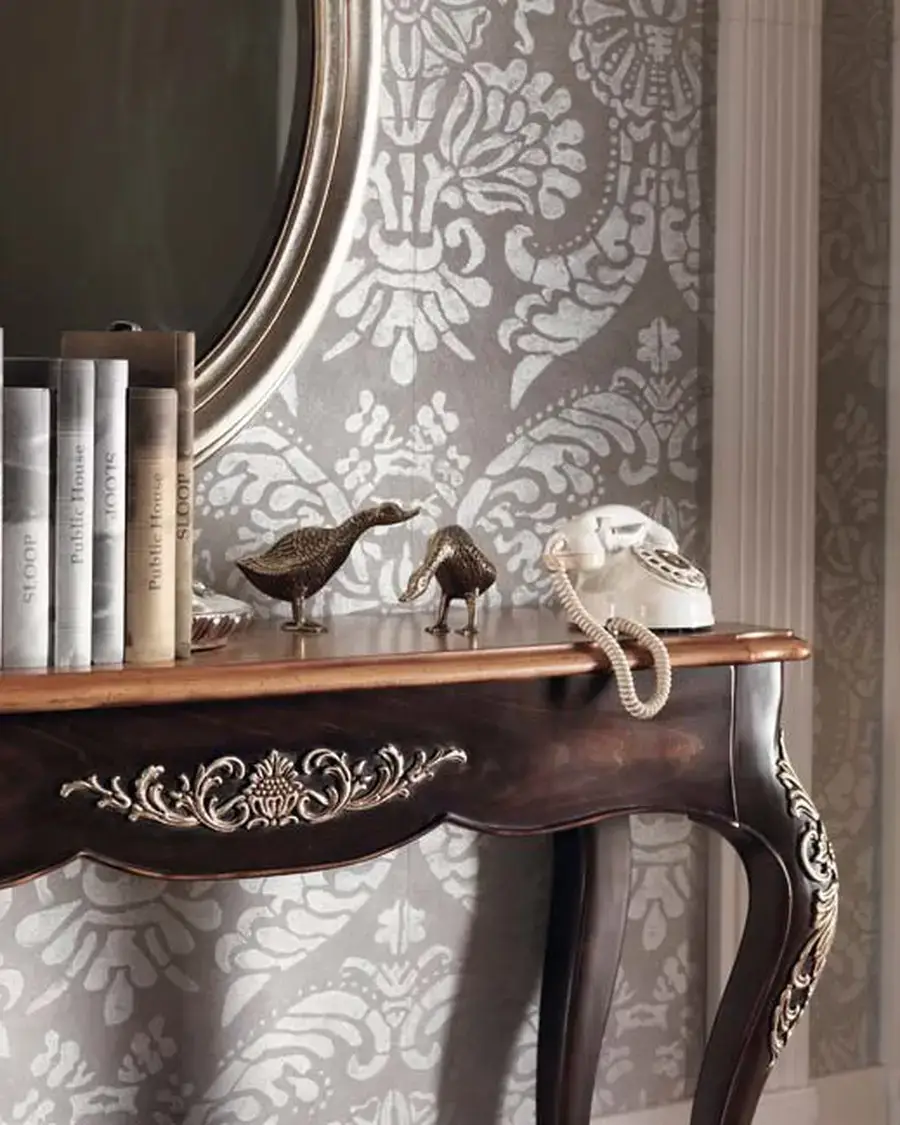Gran Guardia Console Table 2022 by Francesco Pasi, a carved console behind an armchair
