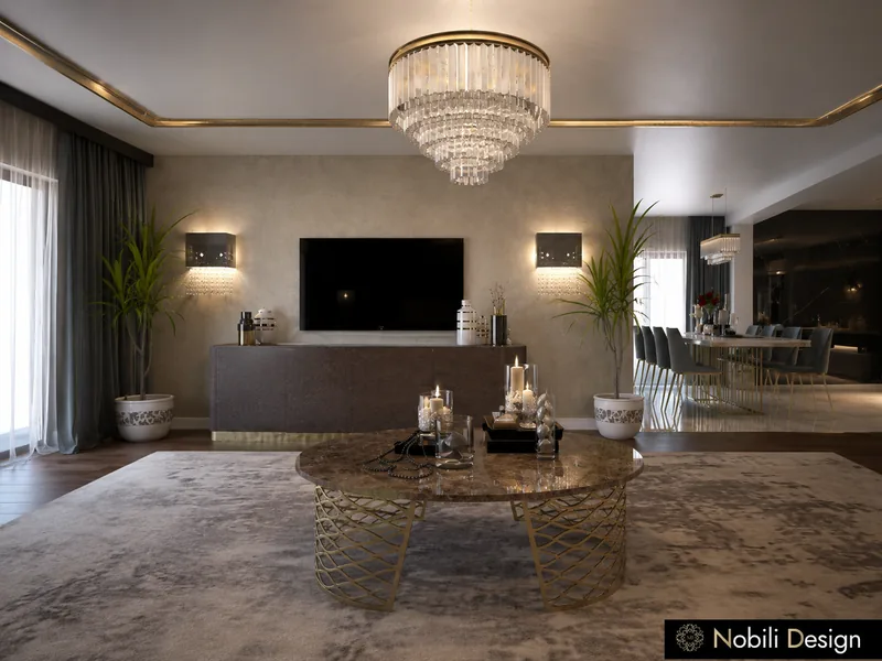 Living room TV wall with a dark console, round marble coffee table on a gold base and wall sconces