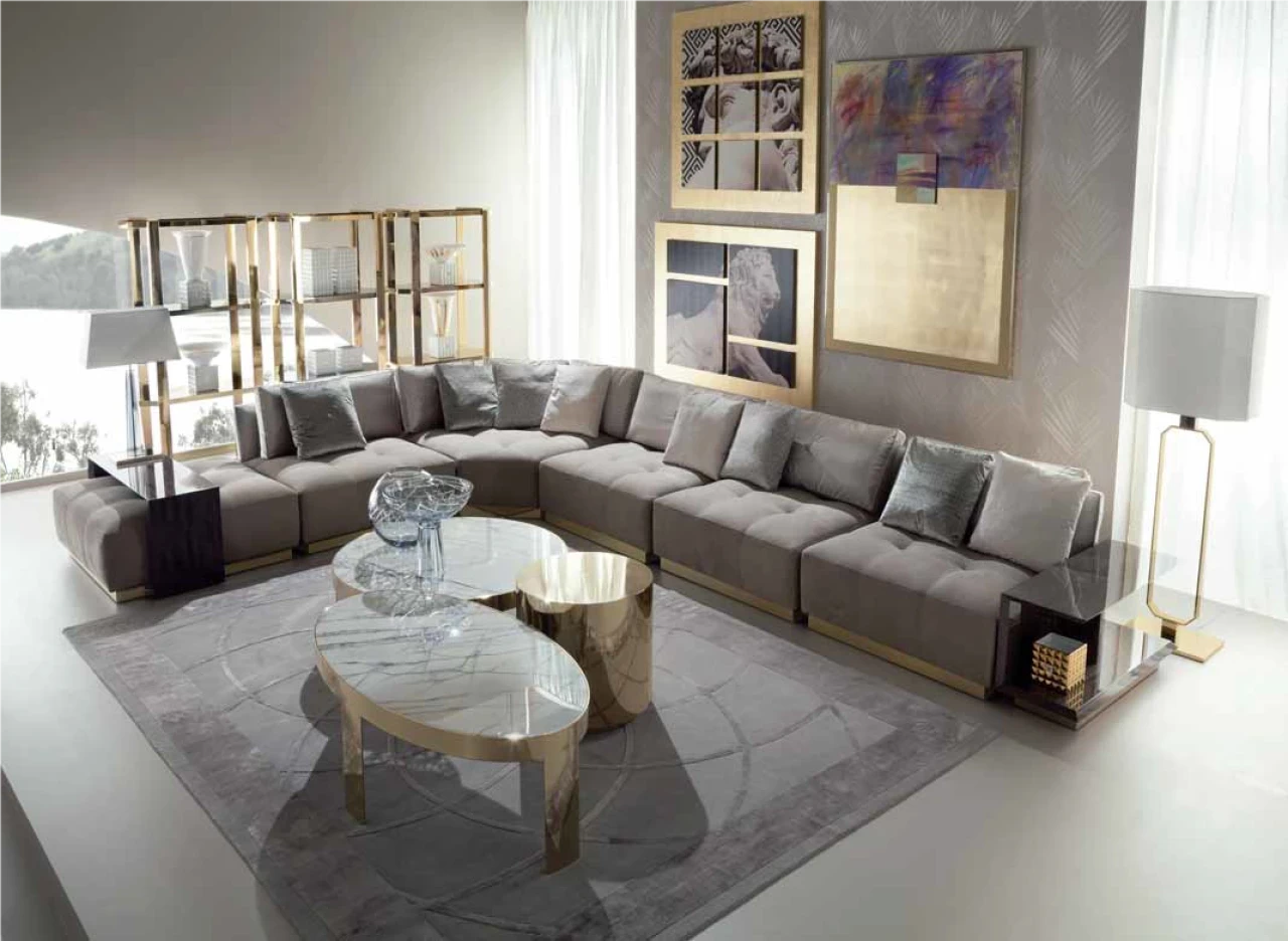 Grey modular sectional sofa around an oval glass coffee table, Italian furniture in Paris